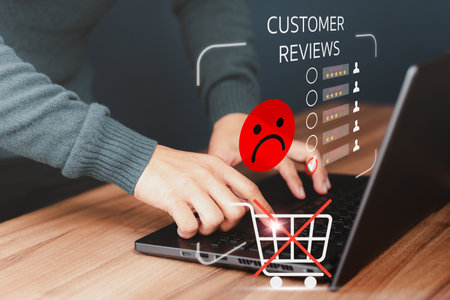Unhappy man customer with sad emotion face on laptop. Bad review and service dislike poor quality, low rating, the order has been cancelled. Customer experience dissatisfied and testimonial concept.の写真素材