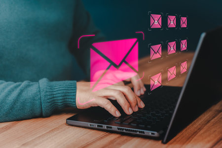 Freelancer's hand using computer laptop and sending online message with email icon, email marketing concept, send email or newsletter, internet network working online.の写真素材