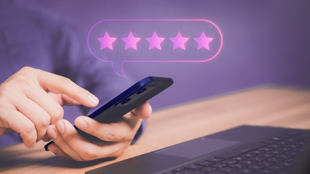 Adult man using a smartphone or mobile phone and give five star symbol to increase rating of product and service concept, Customer service experience, testimonial and business satisfaction survey.の写真素材