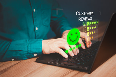 Businessman hand using computer laptop with popup five star icon for feedback review satisfaction service and testimonial. Customer service experience and business satisfaction survey.の写真素材
