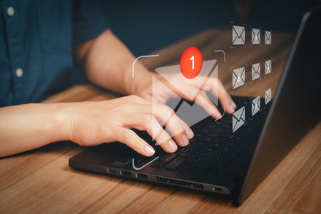 Adult man hand using computer laptop and sending online message with email icon, email marketing concept, send email or newsletter, internet network working online.の写真素材