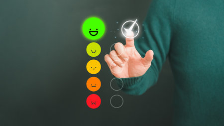 Man touching the virtual screen on the happy smiley face icon to give satisfaction in service. Rating very impressed. Customer service, testimonial and satisfaction concept.の写真素材