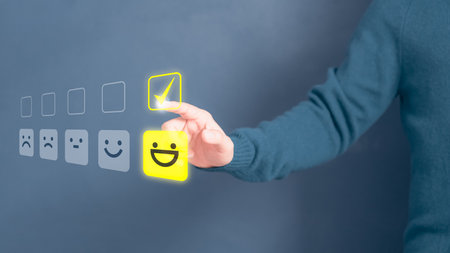 Man touching the virtual screen on the happy smiley face icon to give satisfaction in service. Rating very impressed. Customer service, testimonial and satisfaction concept.の写真素材