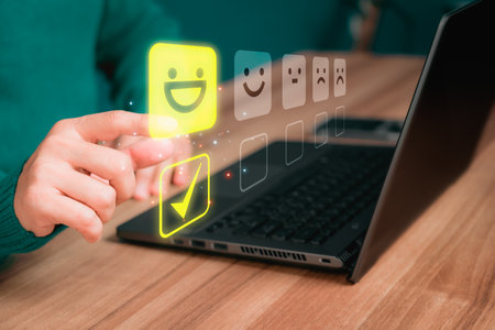 Man hand using computer laptop with popup five star icon for feedback review satisfaction service and testimonial. Customer service experience and business satisfaction survey.の写真素材