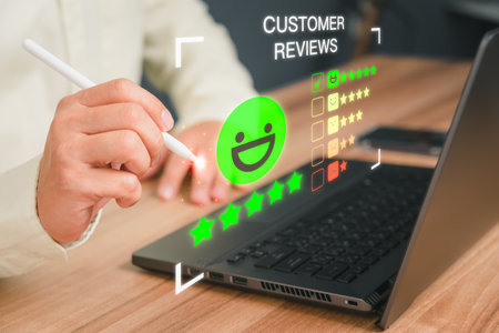 Man hand using computer laptop with popup five star icon for feedback review satisfaction service and testimonial. Customer service experience and business satisfaction survey.の写真素材