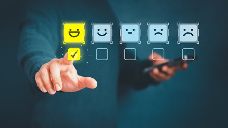 Man touching the virtual screen on the happy smiley face icon to give satisfaction in service. Rating very impressed. Customer service, testimonial and satisfaction concept.の写真素材