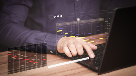 Man working with technology computer in business analytics and data management system to make report with KPI and metrics connected to database. Corporate strategy for operations, planing, marketing.の写真素材