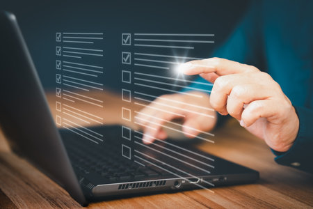 Man using a laptop and touching on virtual screen contact questionnaire with checkboxes. Assessment knowledge test concept, fill out application form, online exam, quiz knowledge and online learning.の写真素材