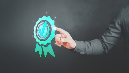 Businessman's hand touching on the sign of the top service the best quality assurance. Assessment product and ISO service, Guarantee, Standards, ISO certification and standardization concept.の写真素材