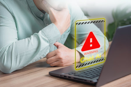 Chat with AI, Artificial Intelligence. Adult man using laptop chatting with a smart AI using an artificial intelligence chatbot with triangle caution warning sign for notification error concept.の写真素材