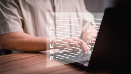 Man using a laptop with virtual screen contact questionnaire with checkboxes. Assessment knowledge...