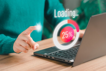 Adult man using a laptop computer for download software and waiting to loading digital business data form website, very slow internet form wifi. Concept of waiting for load of loading symbol.の素材