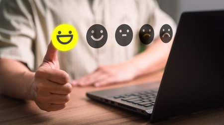 Man touching virtual screen on the happy smiley face icon to give satisfaction in service. Rating very impressed. Assessment customer service, feedback, testimonial and satisfaction concept.の素材