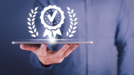 Businessman hand hold tablet show the sign of the top service quality assurance, satisfaction, service experience, ISO certification, standardization guarantee and industrial standard concept.の写真素材