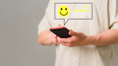 Adult man using a mobile phone or smartphone give rating to service experience assessment opinion on application. Online customer review satisfaction feedback survey and testimonial.の写真素材