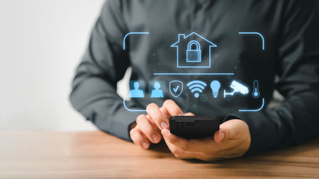 Adult man controlling technology AI smart home devices using a smartphone with launched application in the living room. Iot smart home automation app concept.の写真素材