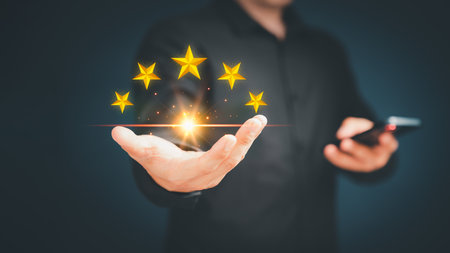 Customer or client man hand showing the stars icon to complete five stars. Assessment customer service giving the five star rating, service feedback, satisfaction and testimonial concept.の写真素材