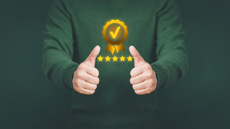 Businessman holding and showing the best quality assurance with golden five stars. Quality assurance of business services, Guarantee, Standards, ISO certification and testimonial concept.の写真素材