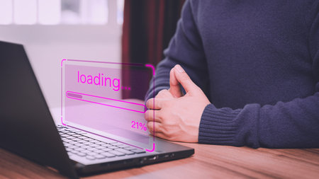 Man using a laptop for download software and waiting to loading digital game online data, update program computer form website, concept of waiting for load of loading bar.の写真素材