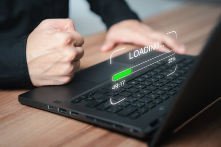 Concept of waiting for load of loading symbol. Employee man using a laptop computer for download software and waiting to loading digital business data form website, very slow internet form wifi.の写真素材