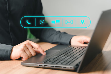 Client man using computer laptop with the virtual screen on the call phone, email, address, chat message and map icons. Customer support hotline contact us people connection concept.の写真素材