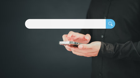 Man using a mobile phone searching browsing internet data information. Business concept for smartphone using search with your website. Search Engine Optimization SEO Networking Concept.の写真素材
