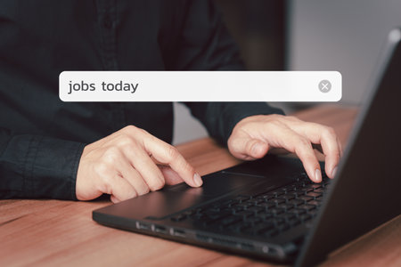 Male hand working with computer laptop on table. Search engine optimization the internet with search bar. Best SEO technology networking, Searching browsing internet data information conceptの写真素材