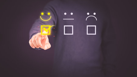 Client hand are touching the virtual screen on the happy smile face icon to give satisfaction in service. Assessment testimonial customer service and feedback, Opinion rating very impressed concept.の写真素材