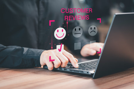 Customer service experience and business satisfaction survey. Man hand using a computer laptop with pop up smiley face icon for assessment feedback review satisfaction opinion and testimonial.の写真素材