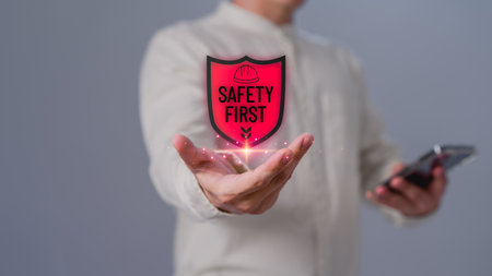 Businessman showing the safety banner symbol on hand. Concept of workplace hazards, Hazard surveillance, Safety first symbol, Working zero accident, Worker safety awareness at work.の写真素材