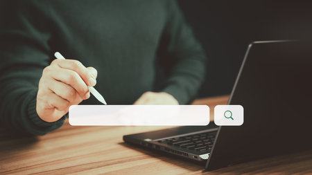 Search engine optimization the internet with search bar. Male hand working with laptop computer on table. Best SEO technology networking, Searching browsing internet data information conceptの写真素材