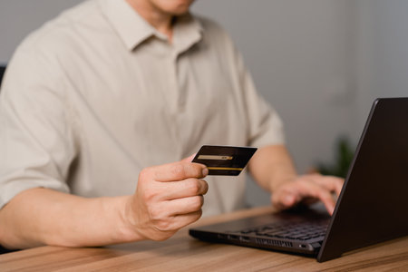 Adult man using laptop to register via credit card to shop online. Credit card secure online shopping and payment. Technology internet banking storage network concept.の写真素材