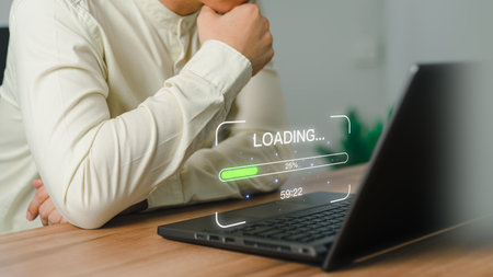 Businessman using a laptop computer for download and update software and waiting to loading digital file data form website, very slow internet form wifi. Concept of waiting for load of loading symbol.の写真素材