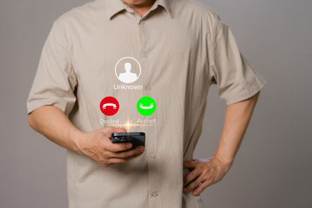 Man answering to incoming call. Phone call from unknown number. Call center gang, scammer or stranger. Hoax person with fake identity. Scam, fraud or phishing with mobile phone or smartphone concept.の写真素材