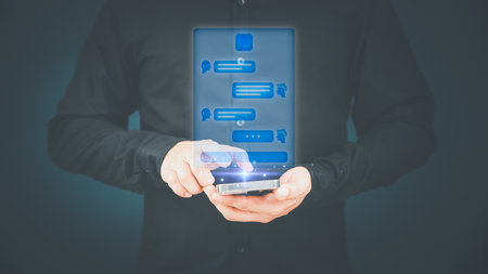 Young man using smartphone chatting with chat bot, Chat with smart AI or Artificial Intelligence technology. Futuristic technology transformation. Chatbot ai communication by mobile phone.の写真素材