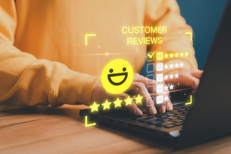 Customer using a computer laptop with pop up smile face and five star icon for assessment feedback review satisfaction and testimonial. Customer service experience and business satisfaction survey.の写真素材