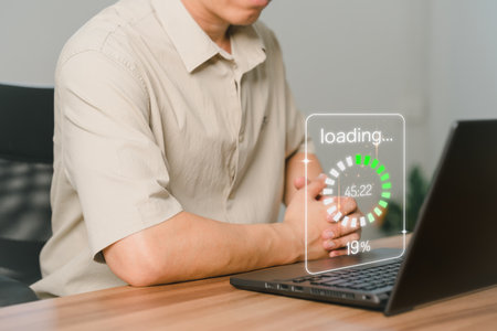 Adult man using a laptop computer for download and update software and waiting to loading digital file data form website, very slow internet form wifi. Concept of waiting for load of loading symbol.の写真素材