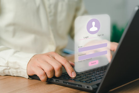 Business man typing his user and password on a computer laptop. Cyber security concept to protect personal data. Secure encryption and access to the user's private information to access the internet.の写真素材