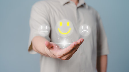 Client hand showing happy smile face icon , good feedback rating, think positive, customer review, assessment, satisfaction, testimonial, good mental health, good mood. Opinion rating very impressed.の写真素材