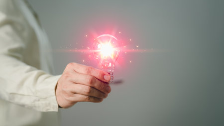 Male hand holding light bulb creative lighting with glowing light bulb Inspiring ideas for learning, technology, new knowledge and sustainable business development. Innovative ideas and inspiration.の写真素材