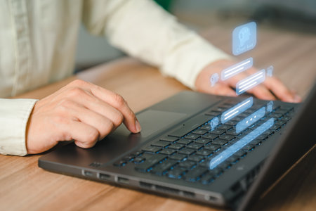 Adult man using a laptop computer chatting with chat bot, Chat with smart AI or Artificial Intelligence technology. Futuristic technology transformation. Chatbot ai communication.の写真素材