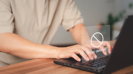 Young man using a laptop to play social media, but the post has been deleted. Searching for more internet, search engine optimizationの写真素材