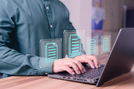 Document management concept with icons on ERP virtual screen. Employee typing on a computer keyboard checking documents in office. Online documentation database to efficiently manage files.の写真素材