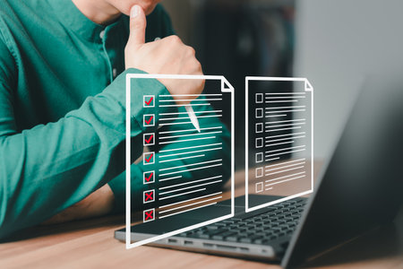Adult man using laptop computer with virtual screen contact questionnaire with checkbox. Assessment knowledge test concept, fill out application form, online exam, quiz knowledge and online learning.の写真素材