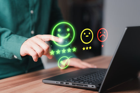 Shopper hand touching the virtual screen on the happy smile face icon for assessment feedback review satisfaction opinion and testimonial. Customer service experience and business satisfaction survey.の写真素材