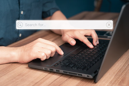 User working with laptop computer on table in office. Search engine optimization the internet with search bar. Best SEO technology networking, Searching browsing internet data information concept.の写真素材