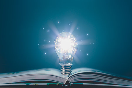 Glowing light bulb with creativity twinkling lights on a book. Ideas for inspiration from reading. Innovation concept of self-learning, education knowledge, technology, business, power of knowledge.の写真素材