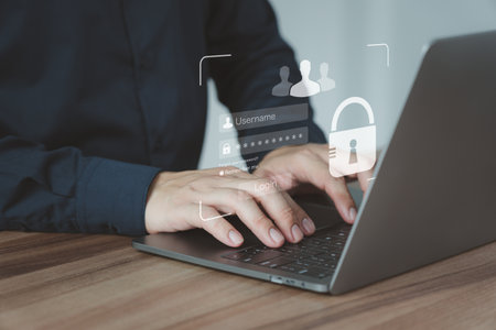 User man protects personal data on a computer laptop and the virtual screen interfaces. Login icon and internet network security technology. Cybersecurity and privacy concepts to protect data.の写真素材
