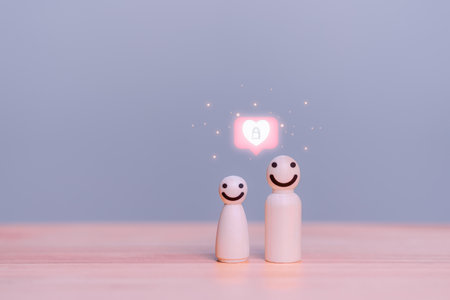 Wooden doll with happy face and heart icon, Relationship with young people, Family relationship, Couple, Husband and wife, Love concept.の写真素材