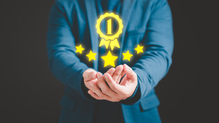 Businessman hand show the best quality assurance with golden warranty symbol. Assessment quality assurance of business services. Guarantee, warranty, standard, ISO certification, testimonial concept.の写真素材